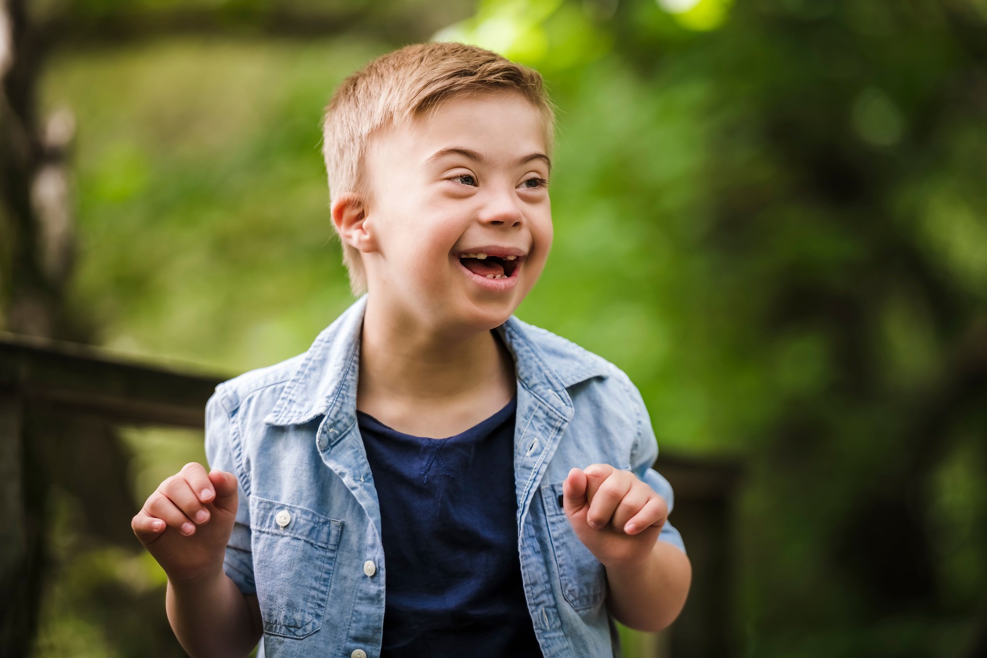Portrait of a little boy with down syndrome while playing in a park
