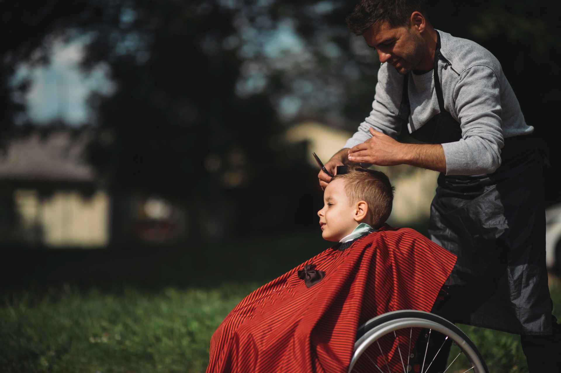 Disable boy having a haircut