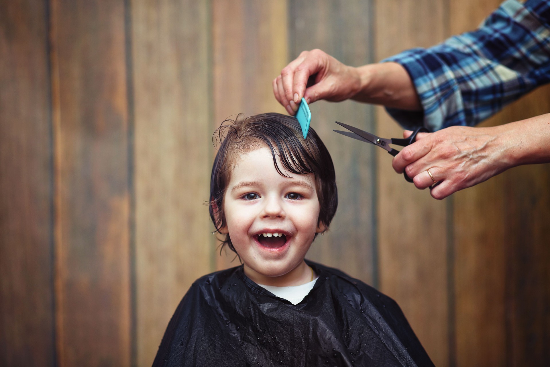 A little boy is trimmed in the hairdresser's